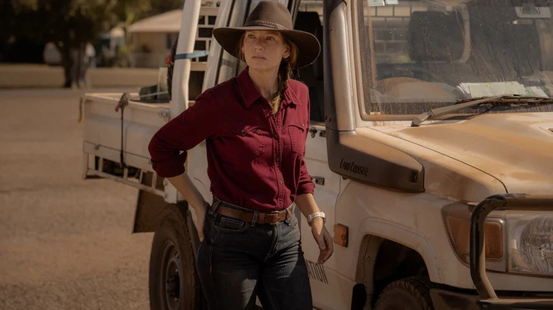Emily Lawson (Anna Torv) stands by a pickup truck in Territory