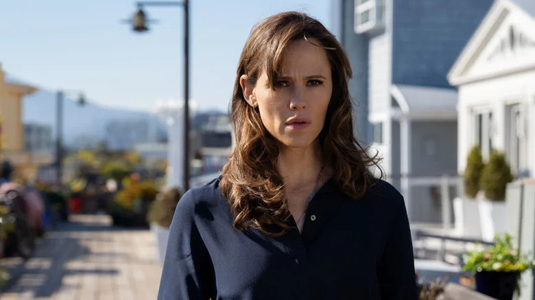 Hannah Hall (Jennifer Garner) walks through a sunny town in The Last Thing He Told Me