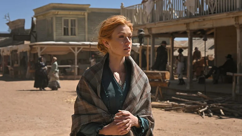 Abby Walker (Katherine McNamara) walks through a frontier town in Walker: Independence