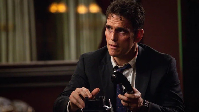 Matt Dillon as Ethan Burke holding old-school phone in Wayward Pines