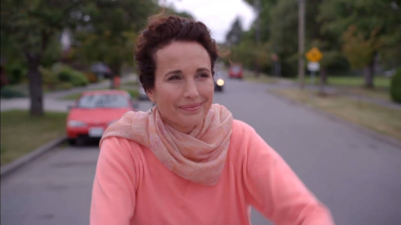 Olivia Lockhart (Andie MacDowell) riding her bike down a street in Cedar Cove