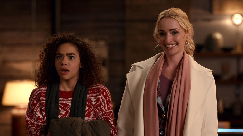 Ginny Miller (Antonia Gentry) looks shocked while standing next to a smiling Georgia Miller (Brianne Howey) in Ginny & Georgia