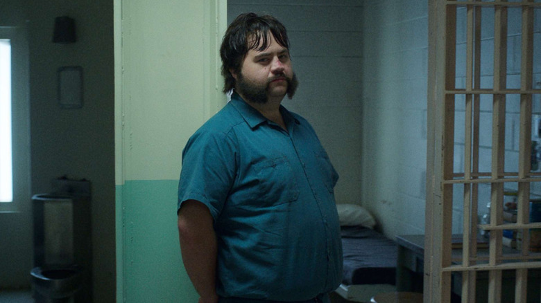 Paul Walter Hauser as Larry Hall, standing near his cell in Black Bird.