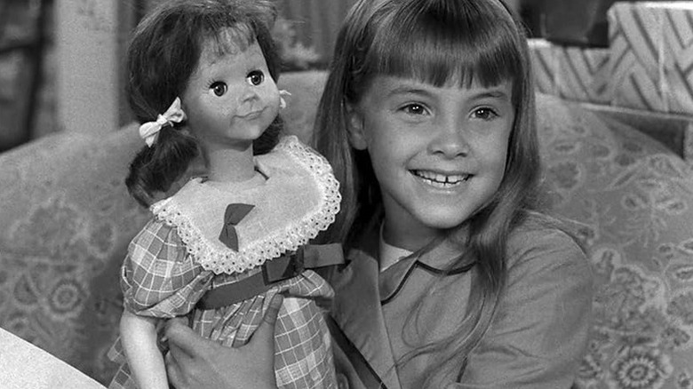 Christie (Tracy Stratford) smiles while holding Talking Tina (June Foray) in The Twilight Zone (1959)