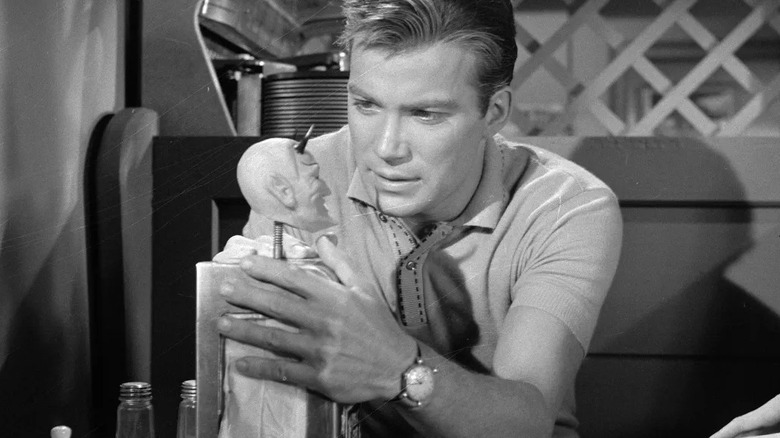 Don Carter (William Shatner) clutches a fortune teller machine in The Twilight Zone (1959)