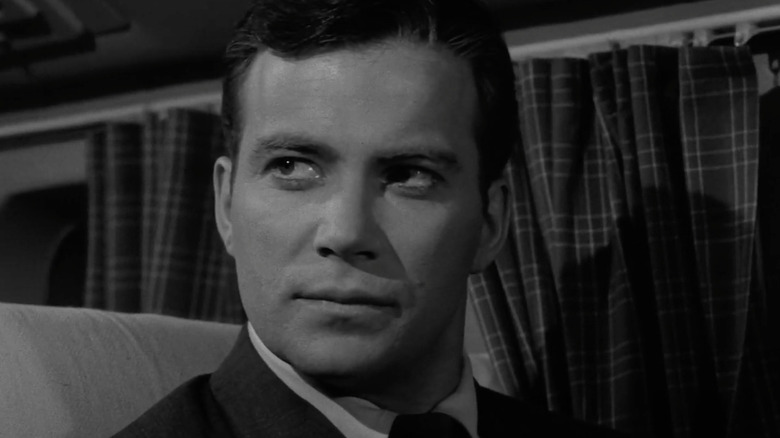 Robert Wilson (William Shatner) sits stoically in an airplane seat in The Twilight Zone (1959)