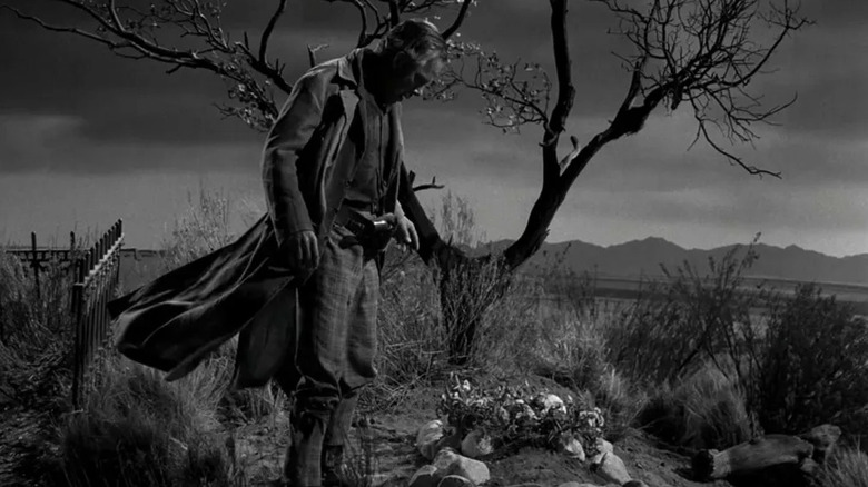 Conny Miller (Lee Marvin) looks down at a grave under a tree in The Twilight Zone (1959)