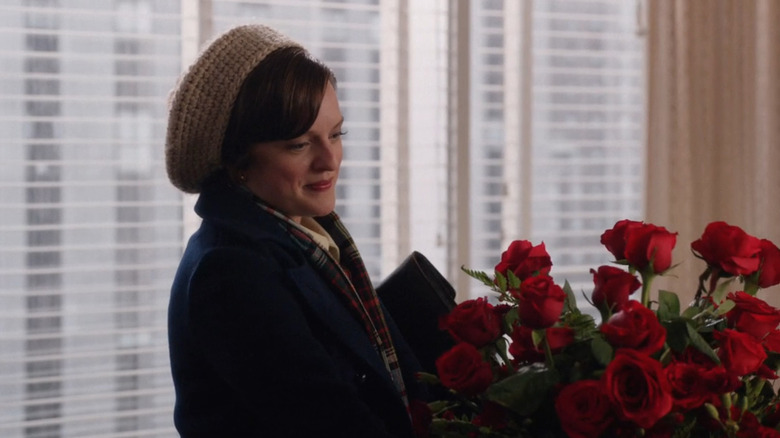 Peggy smiles at bouquet of flowers