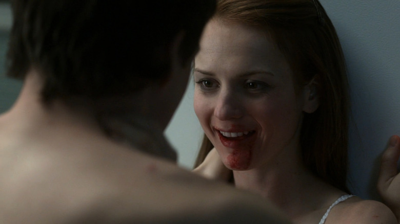 Alice smiles with blood smeared around her mouth