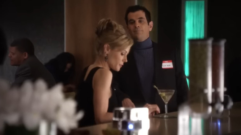 Phil approaches Claire at bar