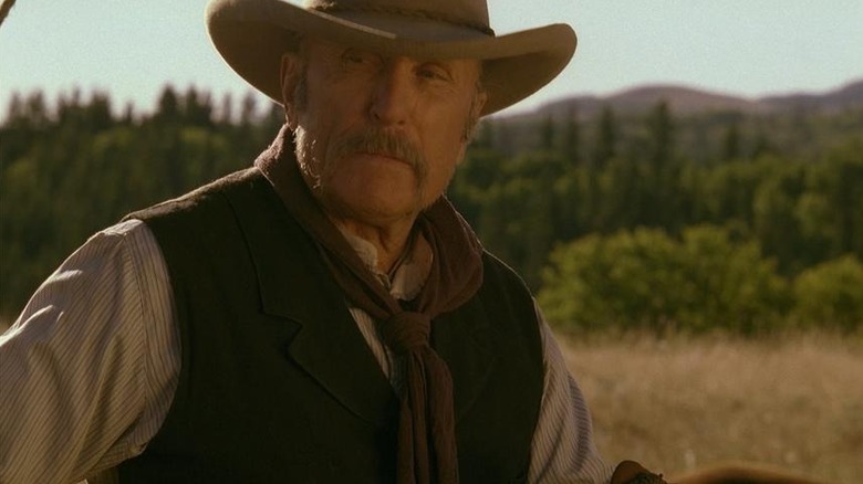 Prent Ritter (Robert Duvall) stares doggedly in a sunset over a forest in Broken Trail