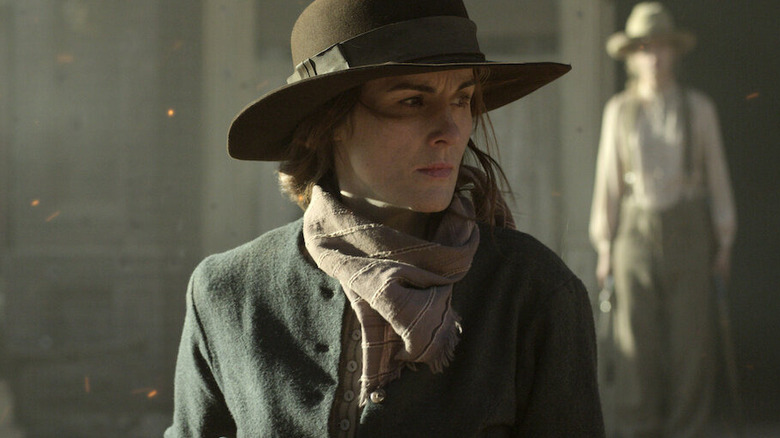 Alice Fletcher (Michelle Dockery) walks through a fiery frontier town in Godless