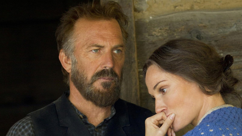 William Anderson Hatfield (Kevin Costner) stares stoically ahead as Levicy Hatfield (Sarah Parish) puts her hand over her mouth in Hatfields & McCoys