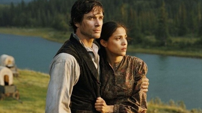Jacob Wheeler (Matthew Settle) holds Thunder Heart Woman (Tonantzin Carmelo) close by a river in Into the West