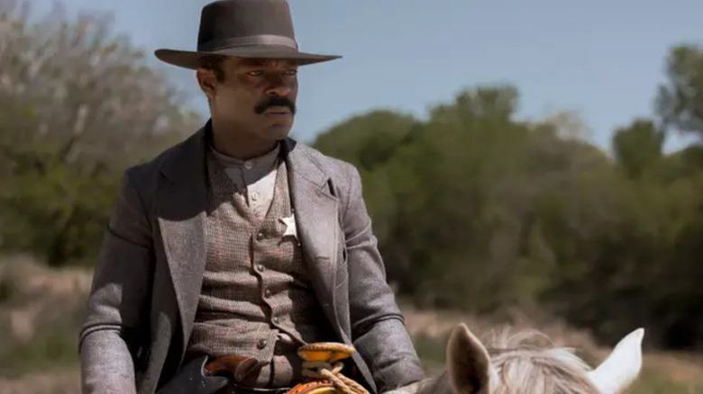 Bass Reeves (David Oyewolo) glares while riding on horeseback in Lawmen: Bass Reeves