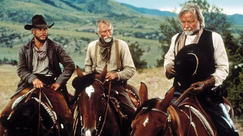 Gideon Walker (Scott Peterson) and Pea Eye Parker (Tim Scott) watch Woodrow Call (Jon Voight) take off his hat in Return to Lonesome Dove