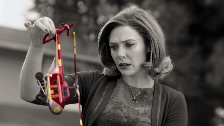 Elizabeth Olsen's Wanda Maximoff holding a red toy helicopter on WandaVision