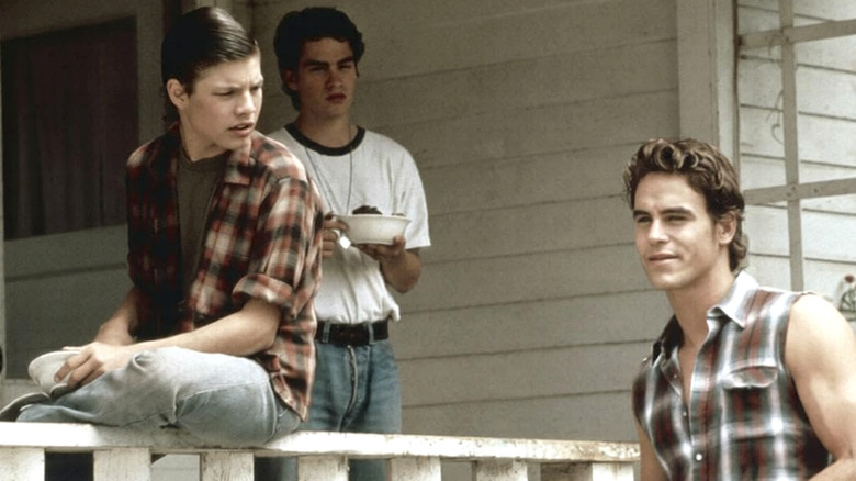 Ponyboy, Sodapop, and Darry hanging out on a porch in "The Outsiders" TV series
