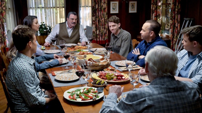 Joe Hill smiling at a Reagan family dinner in "Blue Bloods"