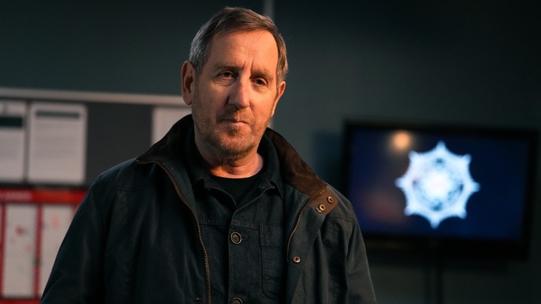 Colly gazes into the camera in Blue Lights