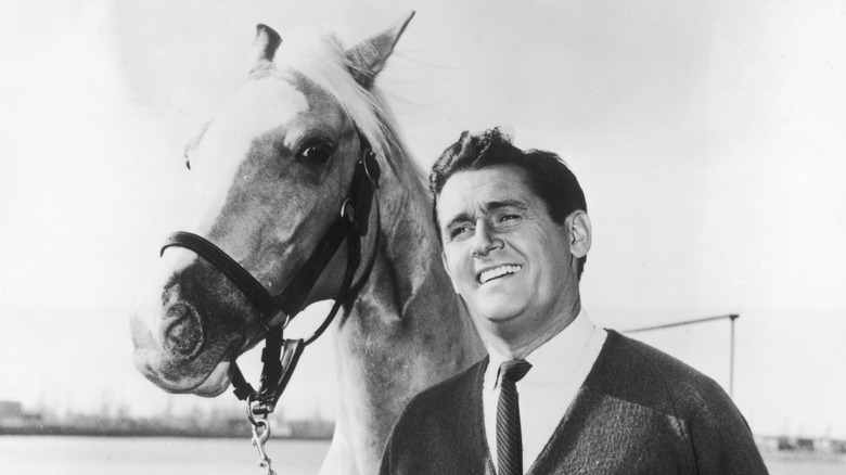 Mister Ed posing next to Wilbur Post, who is smiling proudly