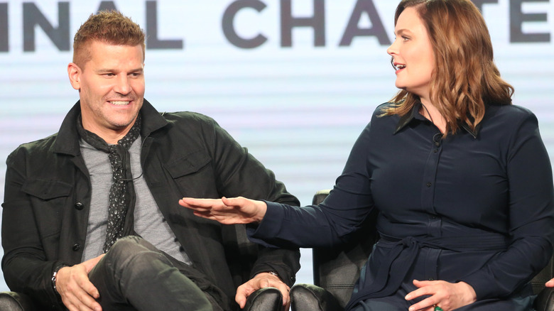 David Boreanaz and Emily Deschanel laugh on a panel