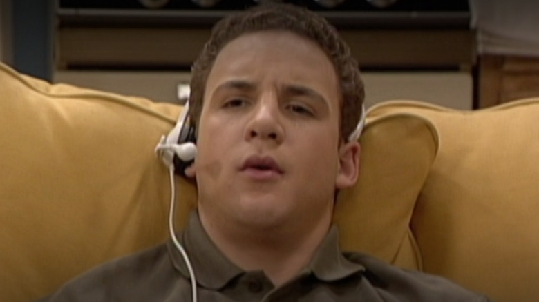 Ben Savage as Cory Matthews sitting on a couch with a head set in Season 7 of Boy Meets World