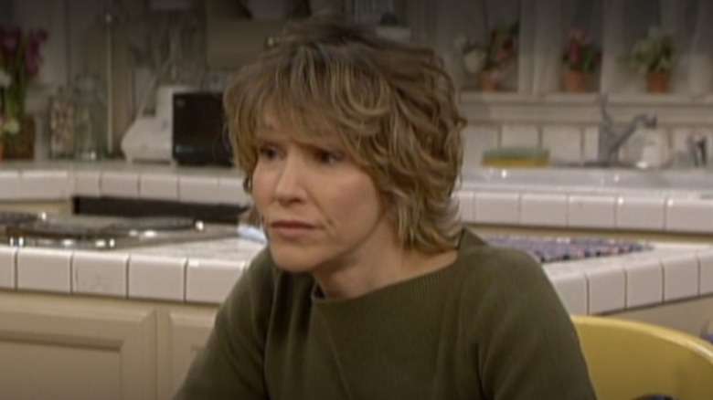 Betsy Randle as Amy Matthews sitting at the kitchen table in Season 7 of Boy Meets World