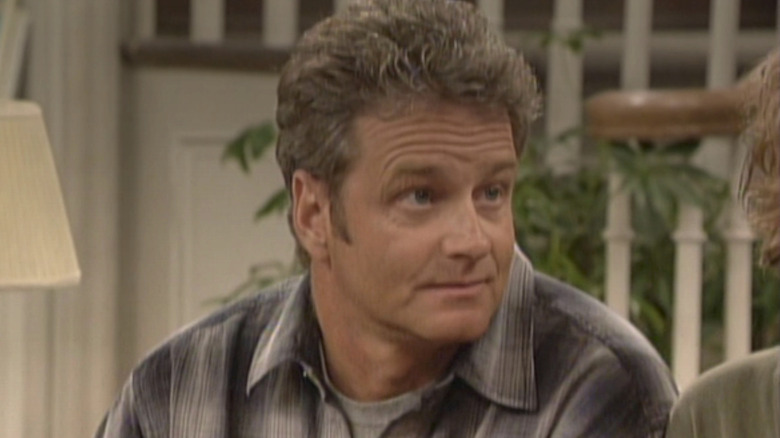 William Russ as Alan Matthews sitting on the couch in Boy Meets World