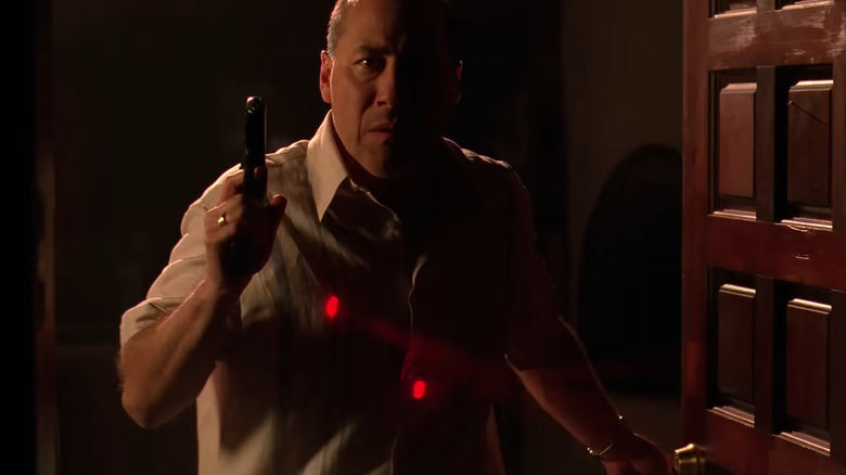 Javier Grajeda as Juan Bolsa, holding a gun with snipers trained on him in Breaking Bad.