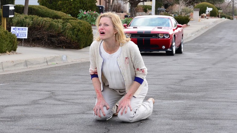 Skyler (Anna Gunn) kneeling on a road on "Breaking Bad."