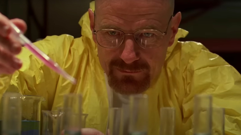 Bryan Cranston's Walter White cooking drugs in a yellow protective suit on Breaking Bad