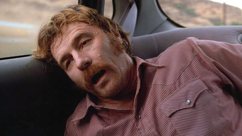 Patrick Crumb lays his head against the car door in pain while wearing a red shirt on The X-Files (1993-2017)