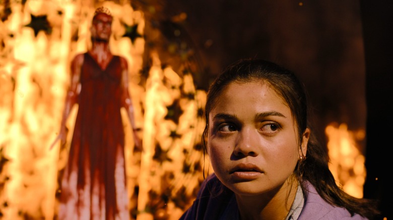 Sue Snell looks away from the fire and blood-soaked woman behind her in "Carrie."
