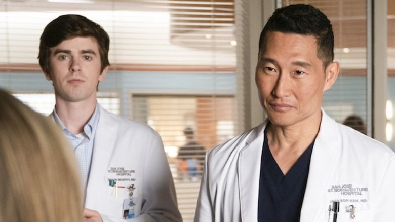 Dr. Shaun Murphy standing next to Dr. Jackson Han, who is smiling at a blonde patient