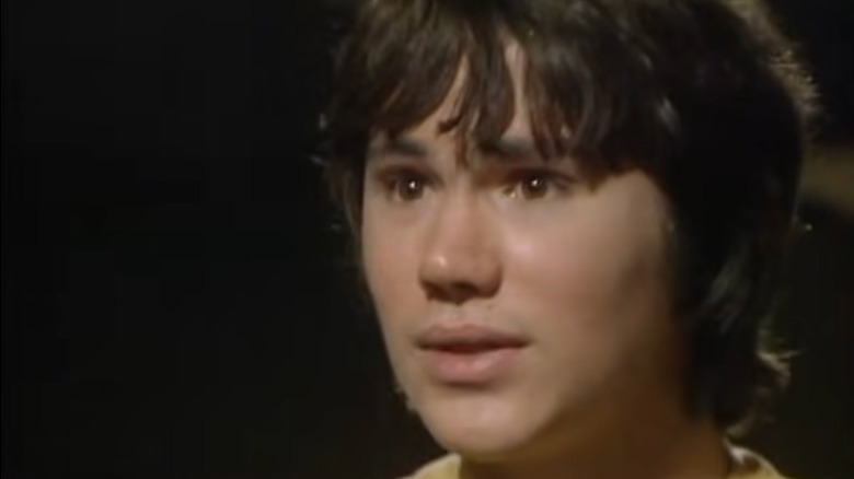 Adric looking to the side, concerned