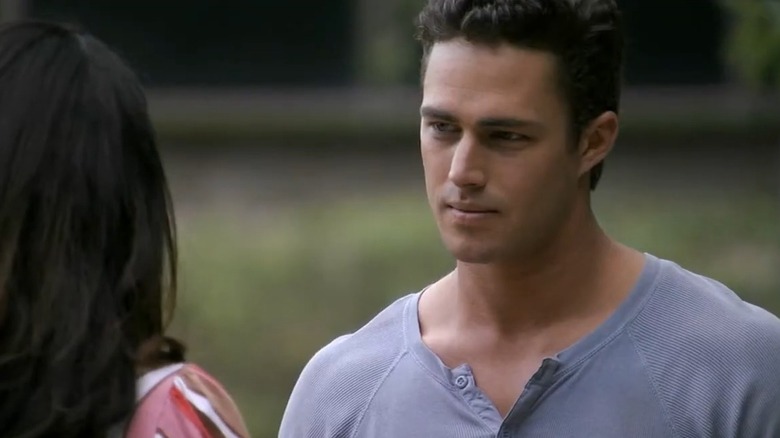 Taylor Kinney as Luke Gianni wearing a grey shirt while talking to Natalie Martinez as Michelle Miller in "Fashion House."