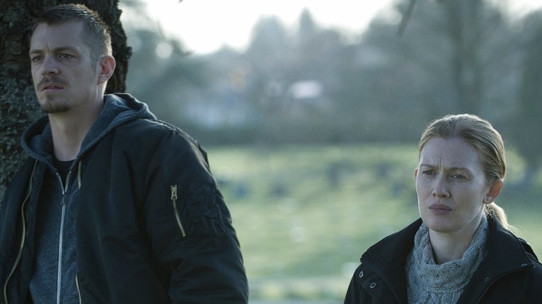 Stephen Holder (Joel Kinnaman) and Sarah Linden (Mireille Enos) stand in a clearing in The Killing