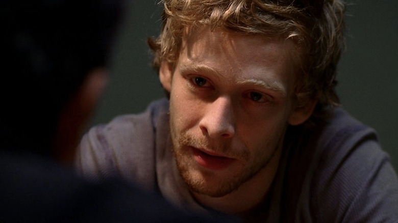Eric Olson sitting in interrogation room in "Criminal Minds" (2005-present)
