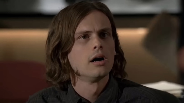 Dr. Spencer Reid looking at something with his mouth open in shock