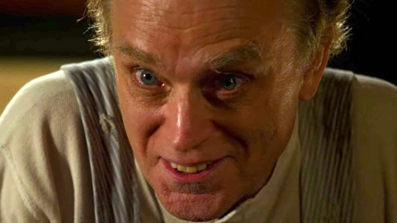 Brad Dourif as Adam Rain, leaning forward with a crazed look on Criminal Minds.
