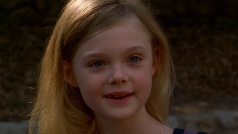 Elle Fanning as Tracy Belle, smiling on Criminal Minds.