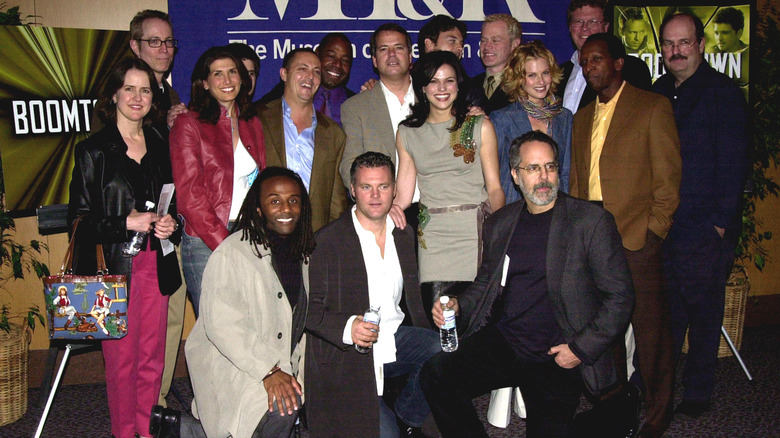 Graham Yost and the cast of "Boomtown" posing for a photo at an event
