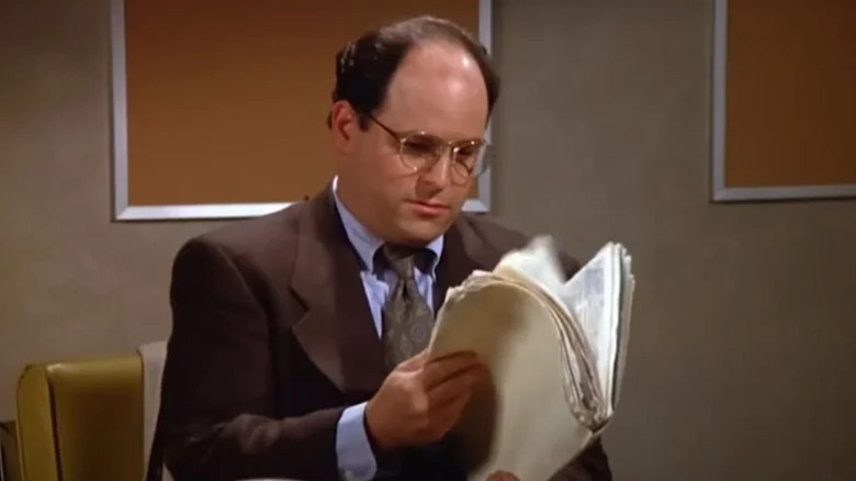 George Costanza reading a file on Seinfeld