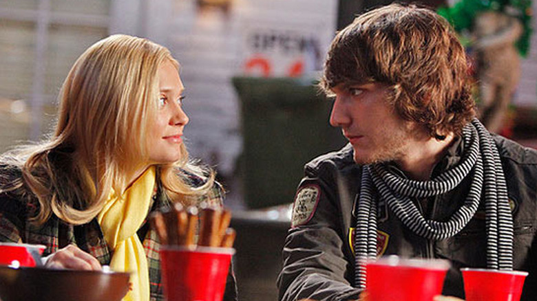 Casey sitting in front of red solo cups next to Cappie in Greek