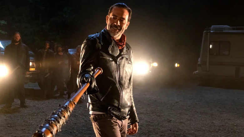 Negan smiling and holding barbed-wire-covered bat in The Walking Dead