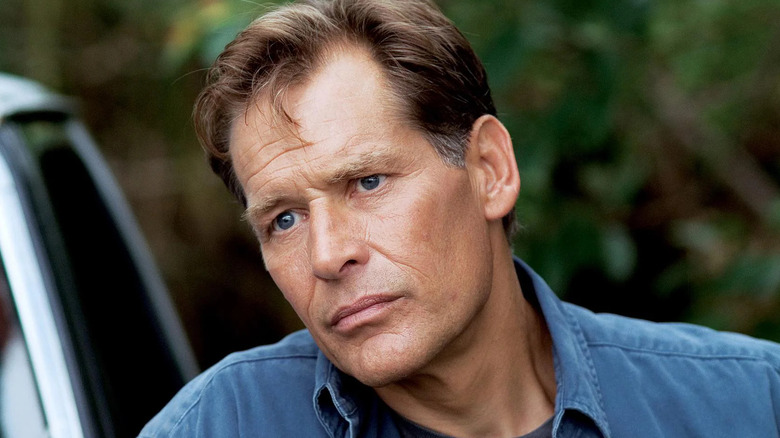 James Remar as Harry Morgan, tilting his head next to a car in Dexter.