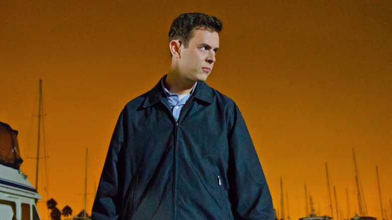 Colin Hanks as Travis Marshall, walking by boats in Dexter.