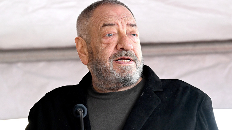Dick Wolf speaking into a microphone