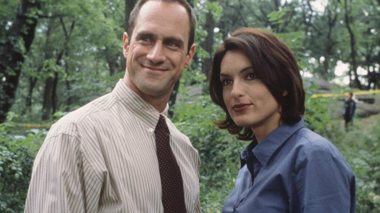 Elliot Stabler and Olivia Benson stand amidst trees in "Law and Order: Special Victims Unit" (1999-present)
